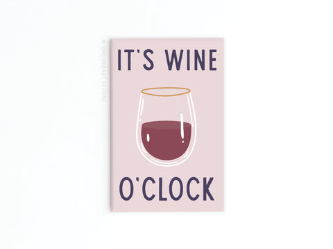 The Onderkast Studio It’s Wine O’clock Refrigerator Magnet features a pink design with a half-filled wine glass and bold text—perfect for kitchen decor or as a gift for wine lovers.