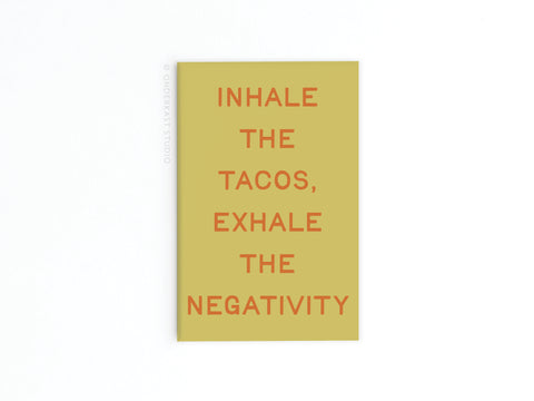 The Inhale the Tacos Refrigerator Magnet by Onderkast Studio features a yellow background with orange text: INHALE THE TACOS, EXHALE THE NEGATIVITY, adding fun humor to your kitchen decor.
