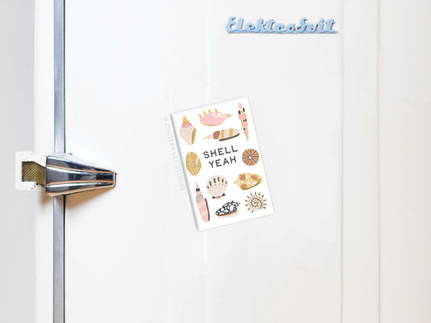 The Shell Yeah Refrigerator Magnet by Onderkast Studio features vibrant seashell illustrations and the phrase SHELL YEAH, making any white fridge with a silver handle pop with its beach-inspired design.
