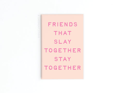 The Friends That Slay Together Refrigerator Magnet by Onderkast Studio features bold pink text on light pink, making it a chic friendship gift or stylish refrigerator décor, shown against a white background.