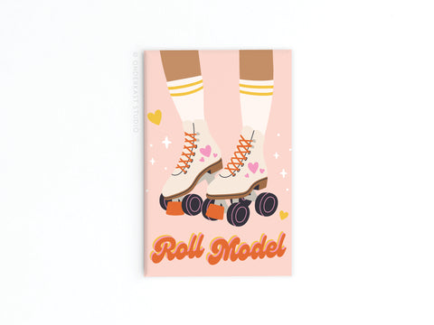 The Roll Model Rollerskates Refrigerator Magnet by Onderkast Studio features a person in white roller skates with orange wheels and yellow-striped socks, surrounded by pink and yellow hearts. Roll Model appears in bold orange letters for a vintage-inspired look.
