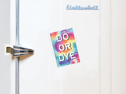 A white refrigerator with a silver handle features the Do Or Dye Tie Dye Refrigerator Magnet by Onderkast Studio. Bold white letters, vibrant colors, and a psychedelic design add flair to this fun accessory.