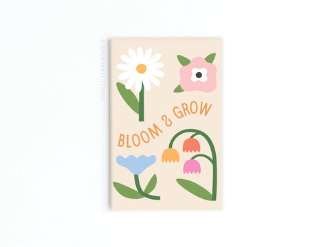 The Bloom & Grow Refrigerator Magnet by Onderkast Studio features a simple floral design and BLOOM & GROW in orange on beige, adding a touch of positivity to any space.