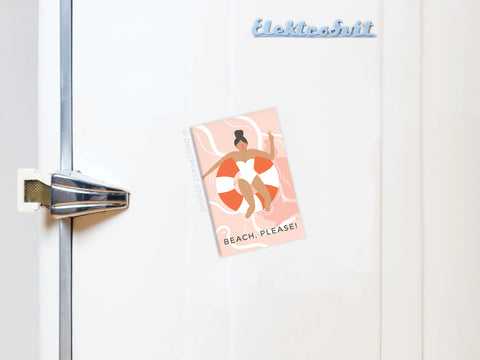 A white fridge with a vintage-style handle features the Beach Please Refrigerator Magnet by Onderkast Studio, which displays a woman lounging on a float and says BEACH, PLEASE!—perfect for coastal vibes decor lovers.