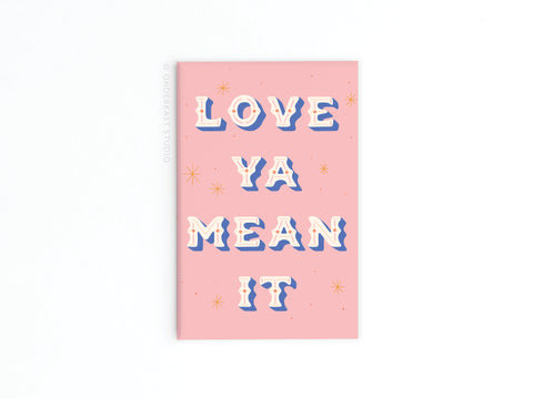 The Love Ya Mean It Refrigerator Magnet by Onderkast Studio features vibrant pink with white, blue, and gold 3D-style LOVE YA MEAN IT text plus gold star accents on a white background.