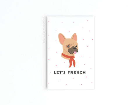 Add extra charm to your kitchen with the Onderkast Studio Let’s French Frenchie Refrigerator Magnet, featuring a French Bulldog in a red scarf and “LET’S FRENCH” text—perfect for dog lovers or as a cute gift. White background with pink dots.