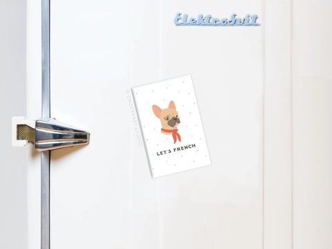 A refrigerator door with an Onderkast Studio Let’s French Frenchie Refrigerator Magnet featuring a cartoon pup in red scarf and sunglasses plus LETS FRENCH text—a perfect gift for dog lovers.