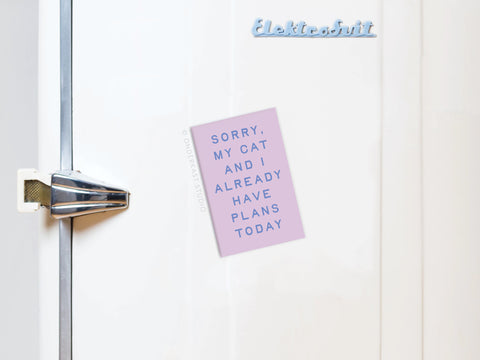 A white fridge with a retro handle displays Onderkast Studios My Cat and I Refrigerator Magnet, showing a cat holding a note that says, SORRY, MY CAT AND I ALREADY HAVE PLANS TODAY in blue capitals—a perfect tribute to feline friendship.