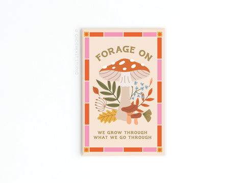 The Forage On Mushrooms Refrigerator Magnet by Onderkast Studio features vibrant mushrooms, leaves, and flowers with FORAGE ON above and We grow through what we go through below, all framed by an orange and pink border.