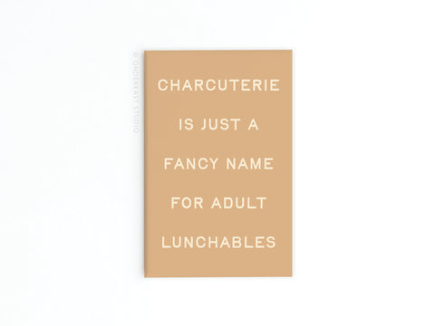 The Charcuterie Adult Lunchables Refrigerator Magnet by Onderkast Studio features white text on beige, adding kitchen sophistication and humor to your space.