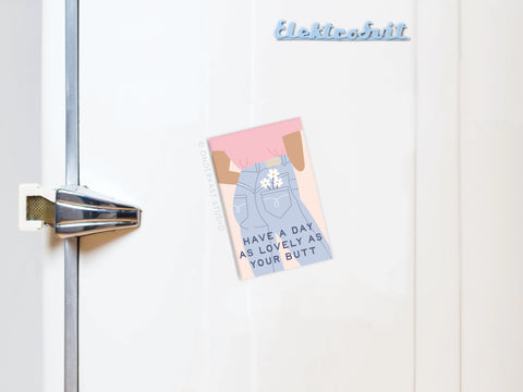 A white vintage fridge with a silver handle displays the Onderkast Studio Lovely As Your Butt Refrigerator Magnet, featuring colorful artwork of a person in jeans and the word Elektrobutt for a fun touch.