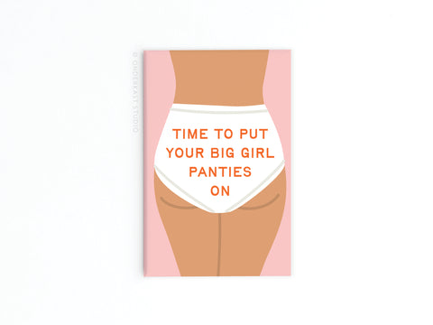 The Onderkast Studio Big Girl Panties Refrigerator Magnet features a womans lower torso in white underwear with TIME TO PUT YOUR BIG GIRL PANTIES ON in bold orange, adding empowering style to any space with its soft pink and white background.