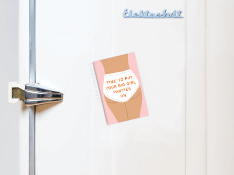 The Big Girl Panties Refrigerator Magnet by Onderkast Studio displays a card with TIME TO PUT YOUR BIG GIRL PANTIES ON over an underwear illustration, attached to a fridge with a metallic handle—an everyday empowerment accessory.