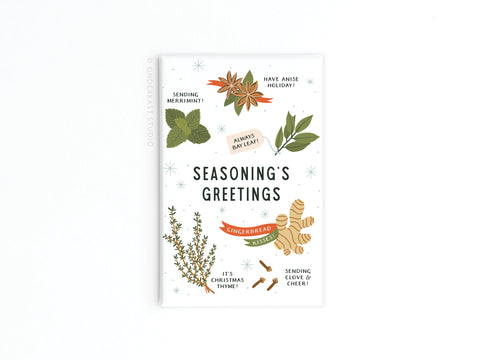 The Seasoning’s Greetings Refrigerator Magnet by Onderkast Studio features illustrated herbs and spices with festive puns—perfect as holiday decor or a fun addition to your fridge.