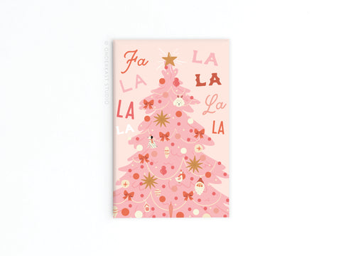 The Onderkast Studio Fa La La Pink Christmas Tree Refrigerator Magnet features a pink tree with ornaments, bows, and stars and Fa La La La La across the top—ideal for festive holiday décor.