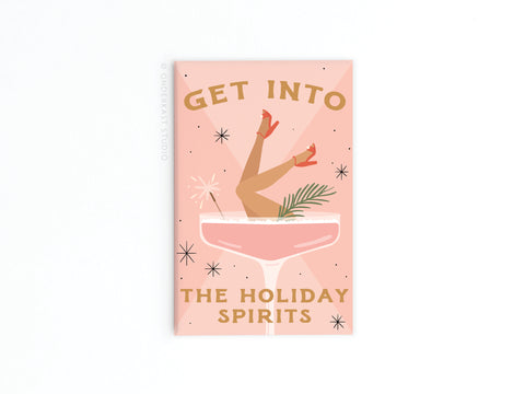 Add festive flair to your fridge with the Into the Holiday Spirits Martini Girl Magnet by Onderkast Studio, featuring a chic martini glass with womans legs in red heels, sparkles, and a palm leaf. A must-have for any magnet collection!.