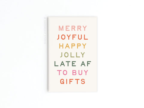 The Onderkast Studio Merry Joyful Late to Buy Gifts Refrigerator Magnet features bold rainbow text on white, reading: MERRY JOYFUL HAPPY JOLLY LATE AF TO BUY GIFTS. A playful holiday accessory, made and printed in the USA.