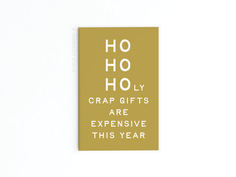 The Ho Ho Holy Crap Gifts Are Expensive Refrigerator Magnet by Onderkast Studio adds cheeky holiday humor to your kitchen with its minimalist gold and white design—perfect for gifting or sprucing up your fridge.