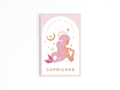 Onderkast Studio’s Capricorn Zodiac Refrigerator Magnet features a woman with long, wavy pink hair and a mermaid tail, surrounded by stars and the Capricorn symbol on a pale pink background, along with dates and CAPRICORN.
