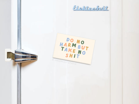 A white fridge with a silver handle displays the Onderkast Studio Do No Harm But Take No Shit Refrigerator Magnet, inspiring empowerment. The word Elektrosvit appears in the top right corner of the refrigerator.