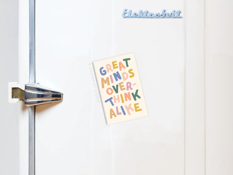 A white fridge with a vintage-style handle displays a colorful Great Minds Overthink Alike magnet by Onderkast Studio, and Elektrobrüt appears on the top right.