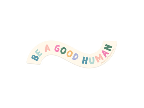 The Be A Good Human Sticker by Onderkast Studio features wavy cream-colored vinyl with playful, colorful letters. This weatherproof sticker adds positivity to your laptop, water bottle, or notebook.