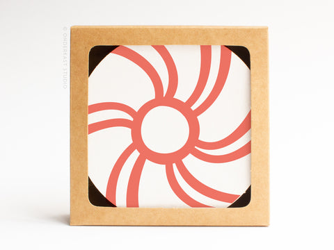 Onderkast Studios Peppermint Candy Coaster Set features handmade-quality letterpress coasters with bold, abstract red swirls on absorbent pulp board, packaged in a square brown box with a circular card inside.