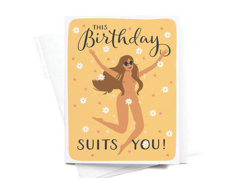 The This Birthday Suits You Greeting Card by Onderkast Studio features a vibrant illustration of a joyful woman in sunglasses, scattered white flowers, and This Birthday Suits You! on a yellow background for a premium feel.