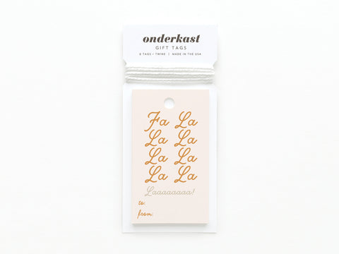 The Fa La La Gift Tag by Onderkast Studio features quality card stock, white string, gold Fa La La La... script, and spaces for to: and from:.