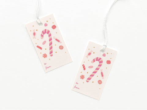 Candy Cane Gift Tags by Onderkast Studio feature pink and red candy canes with assorted candies, “to” and “from” sections, are made of sturdy card stock, printed in the USA, and each comes attached to a white string.
