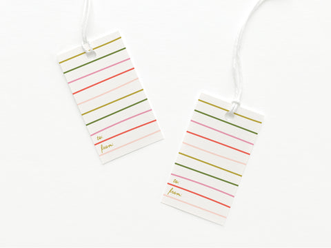 The Onderkast Studio Green & Pink Stripes Gift Tag set includes two sturdy rectangular tags with pastel stripes, gold To: and From:, white strings, and a white surface. Printed in the USA.