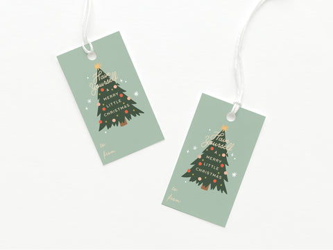 Set of two green Have Yourself a Merry Little Christmas Gift Tags by Onderkast Studio, each featuring a decorated tree, gold holiday text, and white to/from fields. Printed in the USA on quality cardstock with white string included.