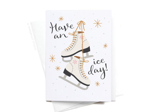 Onderkast Studios Have an Ice Day! Ice Skates Folded Greeting Note Set of 10 features two white ice skates with brown laces, snowflakes, and stars on premium card stock. Includes white envelopes.