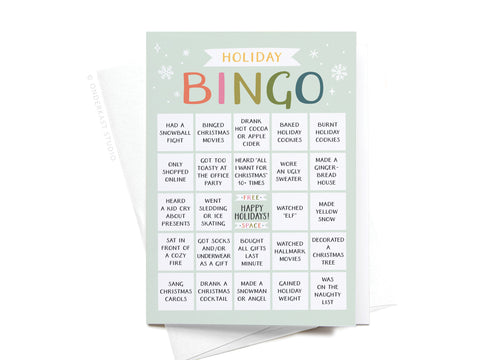 The Onderkast Studio Holiday Bingo Folded Greeting Note Set of 10 features vibrant holiday bingo cards on premium card stock, decorated with snowflakes and festive activities like baking cookies, sipping cocoa, caroling, and crafting.