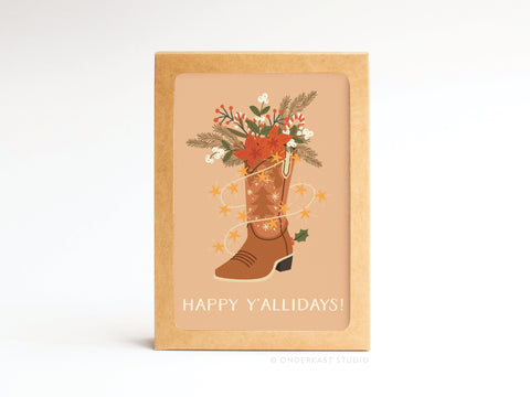 The Happy Y’allidays! Cowboy Boot Folded Greeting Note Set of 10 by Onderkast Studio features premium cards with a festive cowboy boot and “HAPPY YALLIDAYS!” text on beige. Printed in the USA.