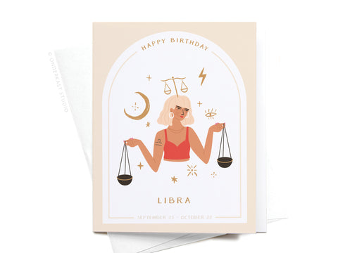 Happy Birthday Libra Zodiac Greeting Card by Onderkast Studio features a short-blonde-haired woman in red holding scales, zodiac symbols, stars, and the moon. Printed in the USA. Celebrates birthdays from September 23–October 22.