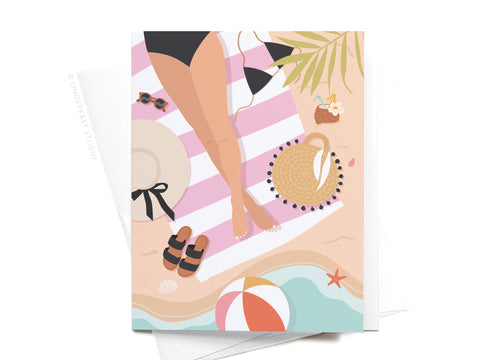 Onderkast Studios Vacay All Day Greeting Card features a vibrant illustration of a woman relaxing on a striped beach towel, surrounded by sandals, sunhat, sunglasses, and tropical details—perfect for sharing vacation vibes.