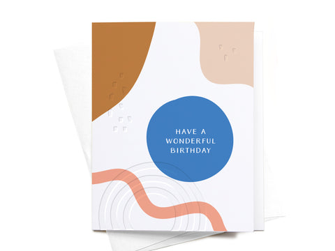 Onderkast Studio’s Have a Wonderful Birthday Abstract Letterpress Greeting Card features brown, pink, blue, and orange shapes plus a blue circle with “HAVE A WONDERFUL BIRTHDAY” in white on a crisp white background. FINAL STOCK.