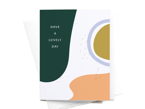 The Onderkast Studio Have a Lovely Day Abstract Letterpress Greeting Card - FINAL STOCK features abstract shapes in dark green, gold, lavender, and peach with white uppercase text on premium cardstock and comes with a white envelope.
