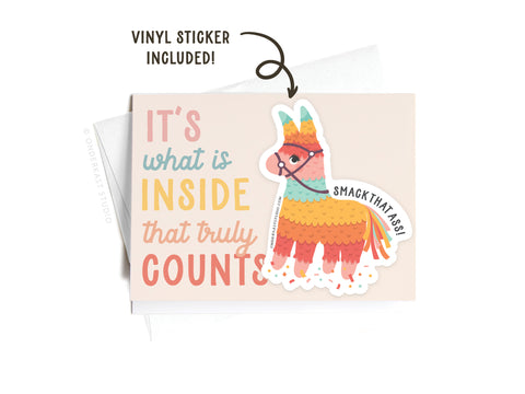 The Onderkast Studio Its What Is Inside That Truly Counts Piñata Sticker Greeting Card features colorful text and includes a removable vinyl sticker of a vibrant piñata labeled Smack That Ass! on thick white card stock.