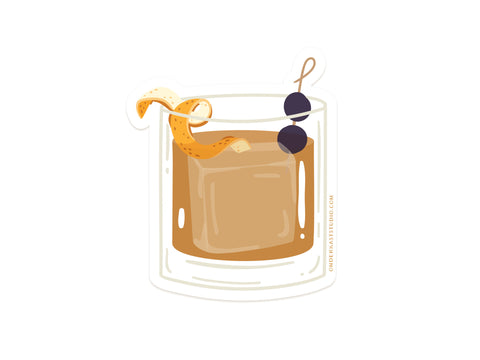 Onderkast Studio’s Old Fashioned Cocktail Sticker features a vibrant illustration of the classic drink with an orange twist and two cherries, printed on durable, water-resistant vinyl—perfect for decorating your favorite surfaces.