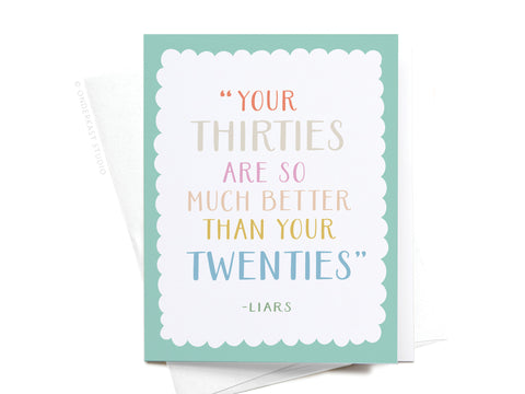 The Your Thirties Greeting Card by Onderkast Studio features pastel text saying “Your thirties are so much better than your twenties – Liars,” with a scalloped white border on a light teal background.