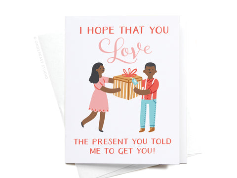 The Onderkast Studio I Hope You Love the Present You Told Me To Get You! Greeting Card, in a dark color, features a smiling man and woman holding a wrapped gift. Printed on premium card stock for a humorous touch.