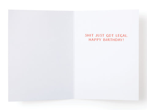 Celebrate this milestone with Onderkast Studios OMG Youre Finally [21] greeting card—blank on the left, featuring SHIT JUST GOT LEGAL. HAPPY BIRTHDAY! in bold red on the right—the perfect card for turning 21.