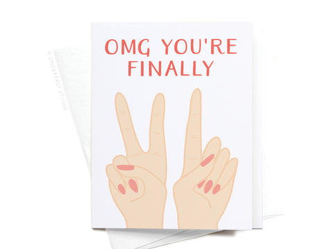Celebrate a milestone with the Onderkast Studio OMG Youre Finally [21] Greeting Card, featuring two hands with painted nails forming the number 21 and bold red text above them. The perfect card for a 21st birthday!.