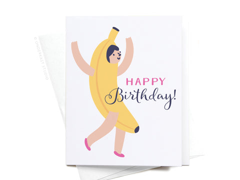 The Happy Birthday! Banana Suit Girl Greeting Card by Onderkast Studio shows a smiling girl in a banana suit with arms raised, “HAPPY BIRTHDAY!” text, and comes with a partially visible light-colored envelope.